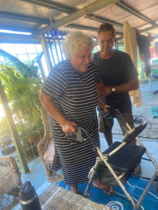 Man helping woman with walker